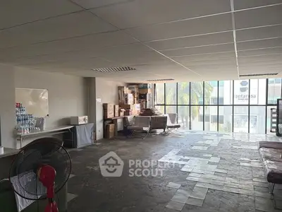 Spacious commercial office space with large windows and ample natural light, ideal for business operations.