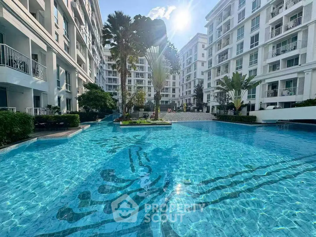 Luxurious apartment complex with stunning pool and lush greenery, perfect for modern living.