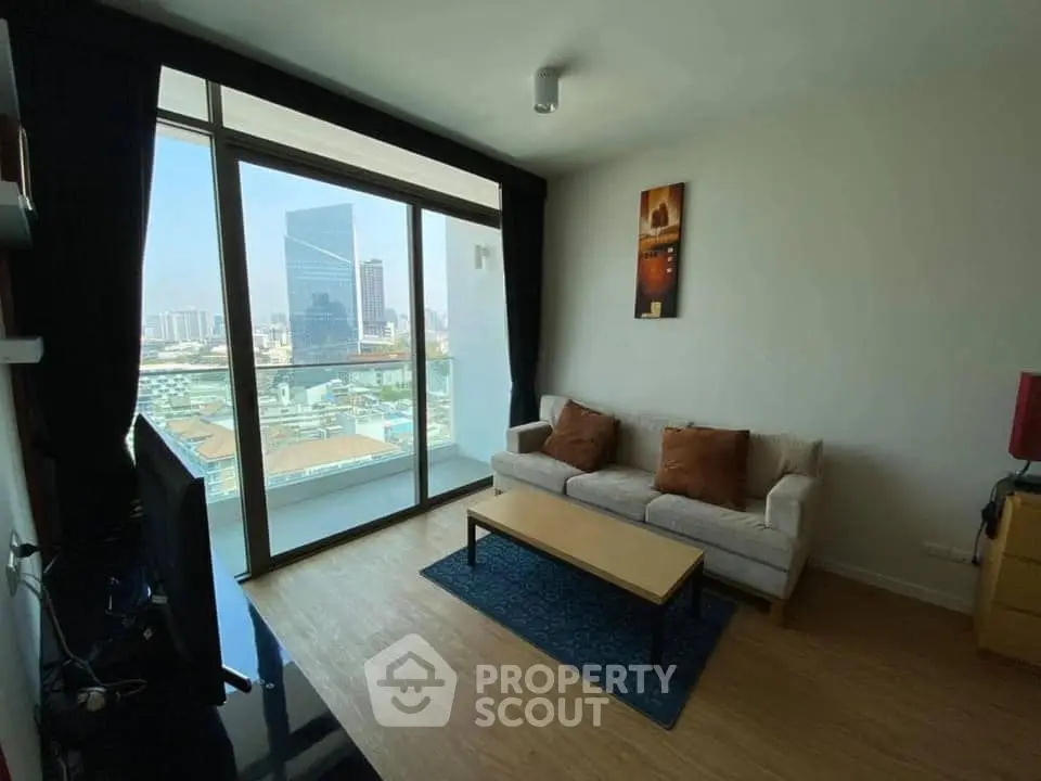 Modern living room with city view and stylish decor in high-rise apartment.