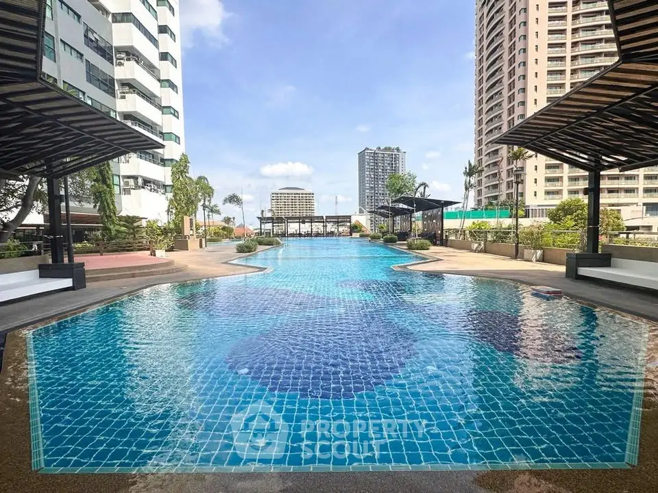 Luxurious outdoor swimming pool with modern design in urban high-rise setting.