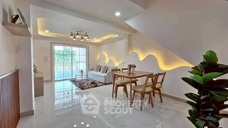 Modern living room with stylish lighting and elegant dining area