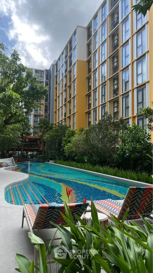 Luxurious apartment complex with stunning pool and lush greenery, perfect for relaxation and modern living.
