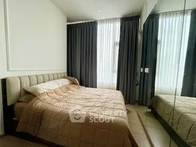 Cozy bedroom with mirrored wardrobe and elegant curtains
