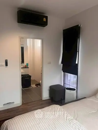 Cozy bedroom with ensuite bathroom and modern air conditioning unit