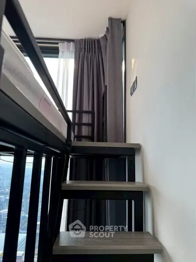 Modern loft bedroom with city view and stylish staircase