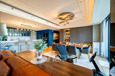 Luxurious open-plan living and dining area with modern decor and elegant lighting.