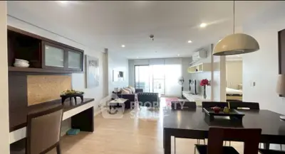 Spacious modern living room with dining area and balcony access