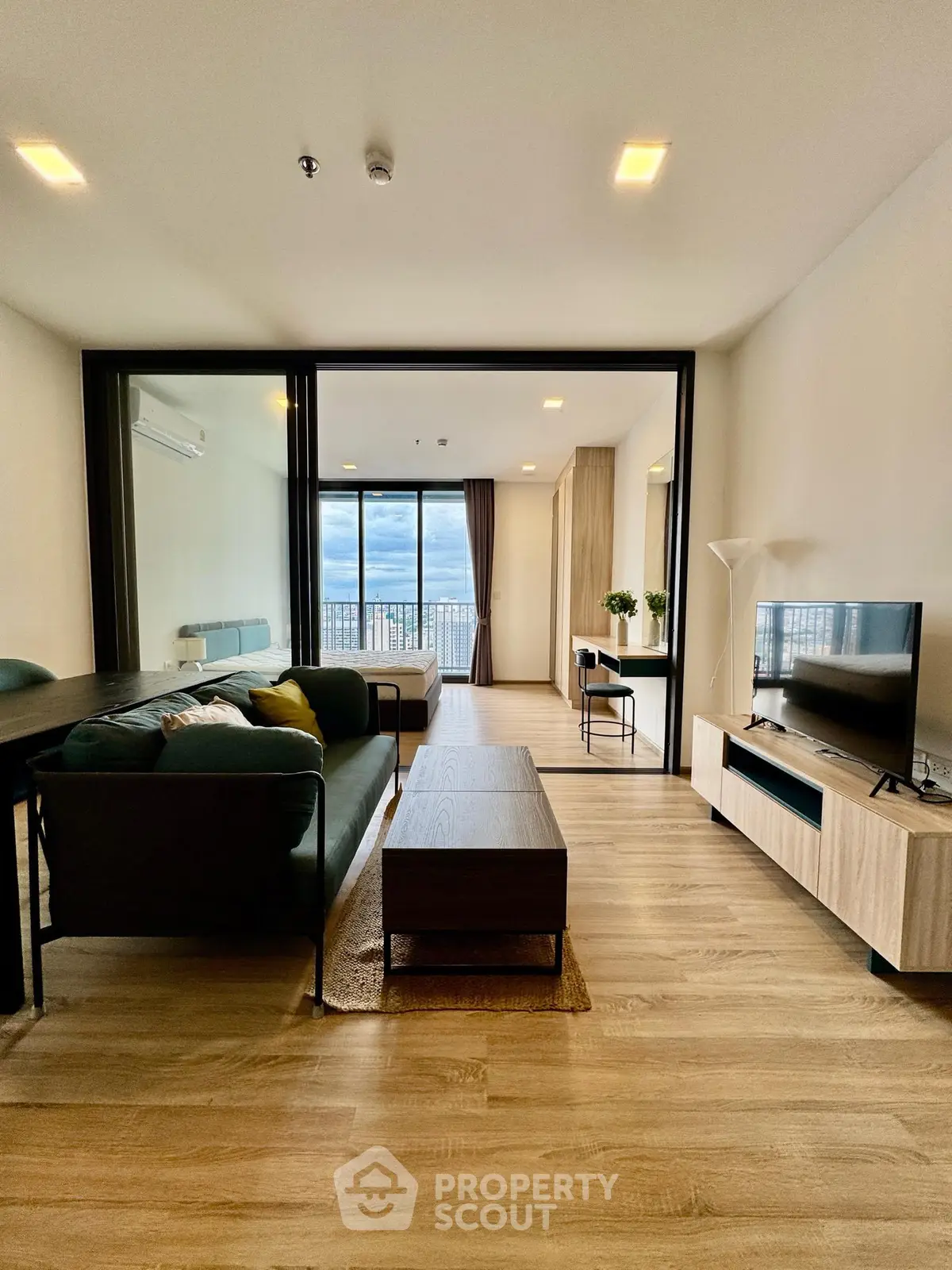 Spacious modern living room with large windows and stunning city view