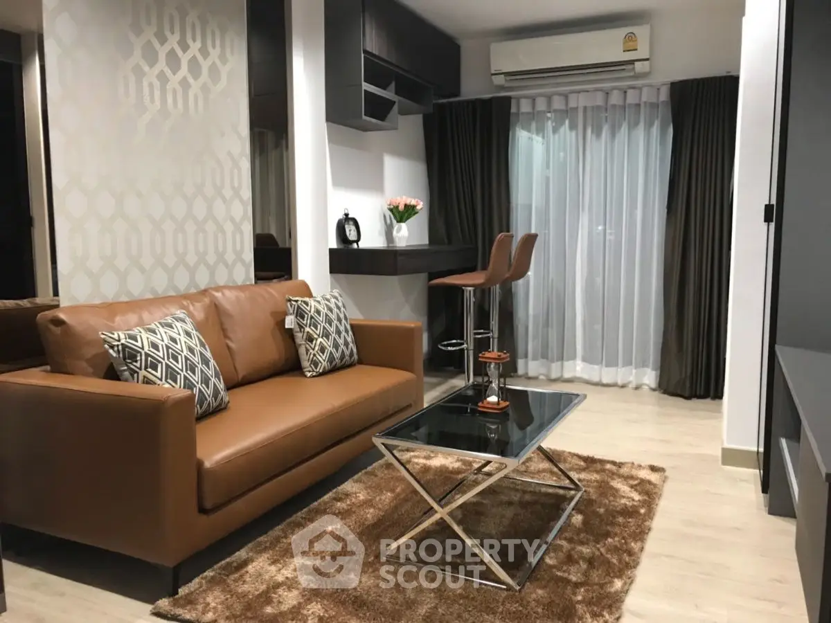 Modern living room with stylish brown leather sofa and sleek decor