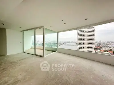 Spacious corner unit with panoramic city and river views, featuring a large balcony and open layout.