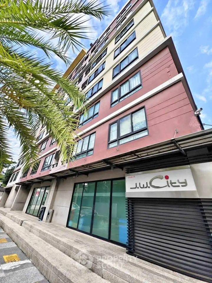 Modern multi-story building with sleek design and large windows in urban setting.