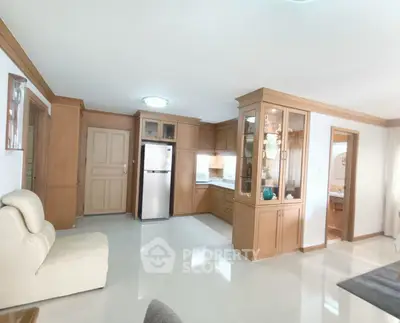 Spacious living room with open kitchen and elegant wooden cabinetry