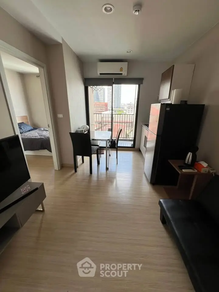 Modern apartment interior with open living area and city view balcony.