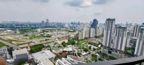 Stunning cityscape view from a high-rise balcony showcasing urban skyline and modern architecture.