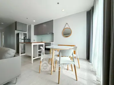 Modern open-plan living room with dining area and sleek kitchen design