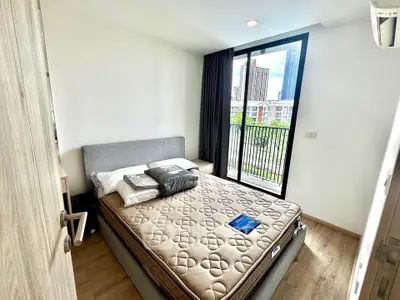 Cozy bedroom with modern decor and city view from window