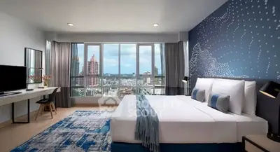 Spacious modern bedroom with city view, stylish decor, and natural light.