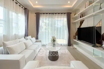 Luxurious modern living room with elegant white sofas and large TV