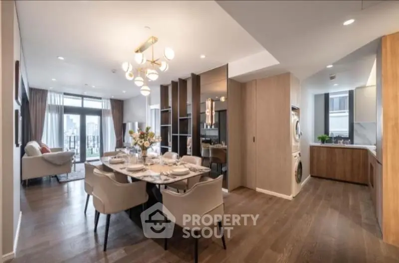 Luxurious open-plan living and dining area with elegant decor and city view.