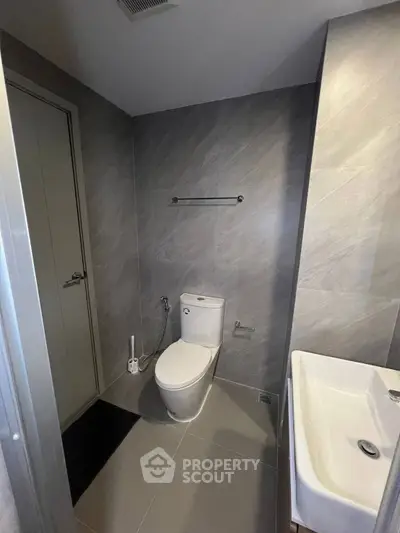 Modern bathroom with sleek gray tiles and contemporary fixtures
