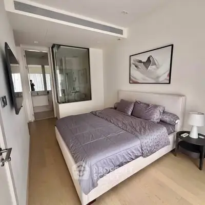 Modern bedroom with ensuite bathroom and stylish decor in a luxury apartment.