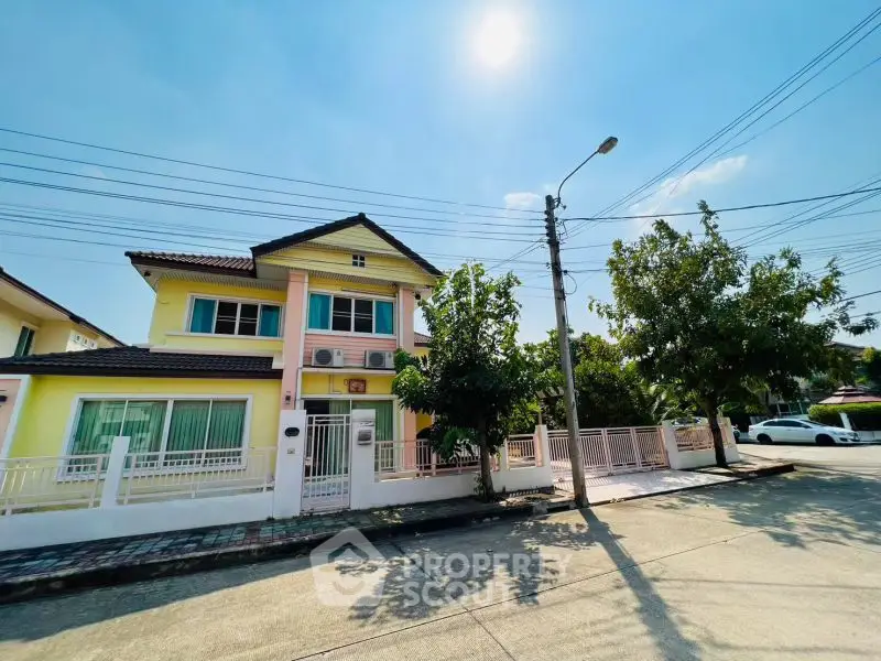 Charming two-story house with spacious yard and sunny street view.