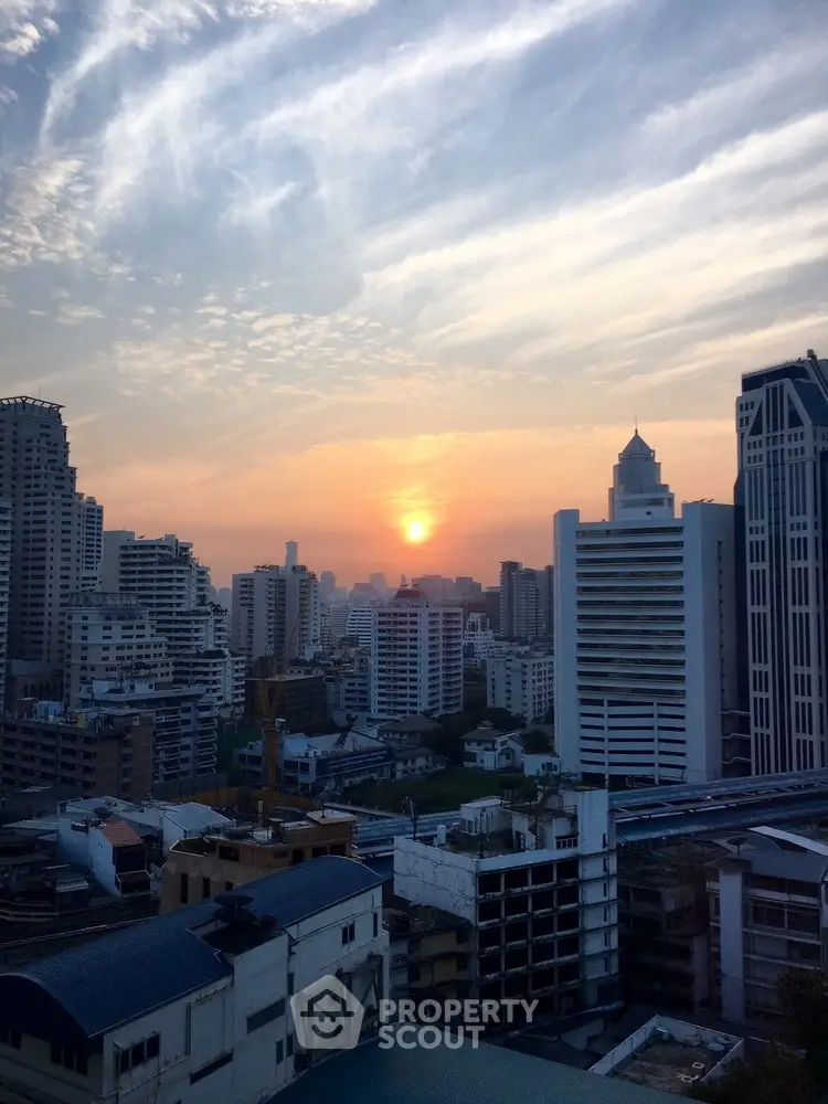 Stunning cityscape view with sunset over urban skyline, perfect for high-rise living enthusiasts.