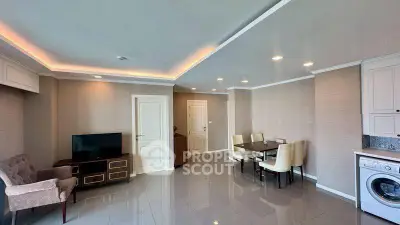 Modern living room with dining area and washing machine, featuring sleek design and ample lighting.