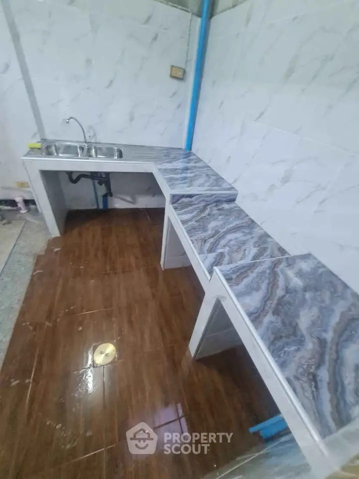 Modern kitchen with marble countertops and stainless steel sink