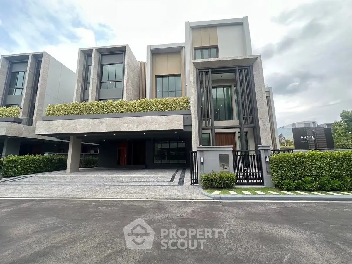 Luxurious modern townhouse with sleek design and spacious driveway in a serene neighborhood.