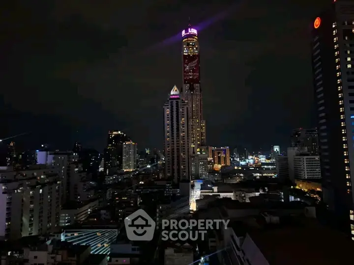 Stunning night view of city skyline with illuminated skyscrapers and vibrant urban lights.