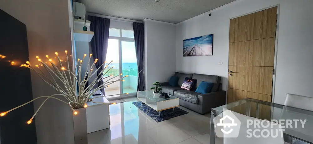 Modern living room with ocean view, stylish decor, and natural light