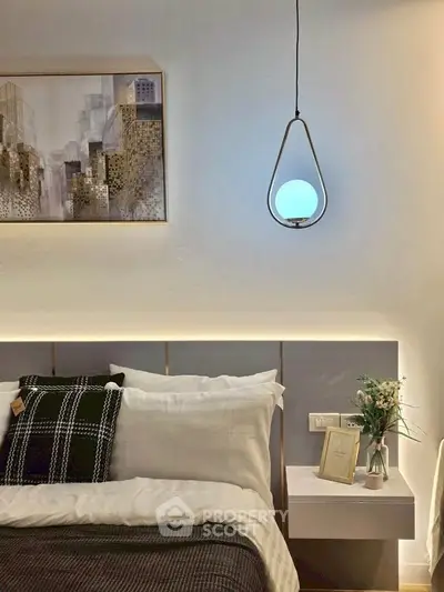 Modern bedroom with stylish pendant light and elegant decor