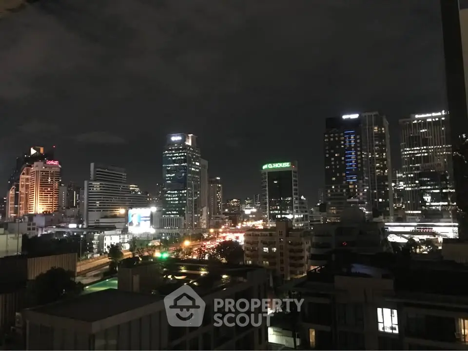 Stunning nighttime cityscape view with illuminated skyscrapers and bustling streets.