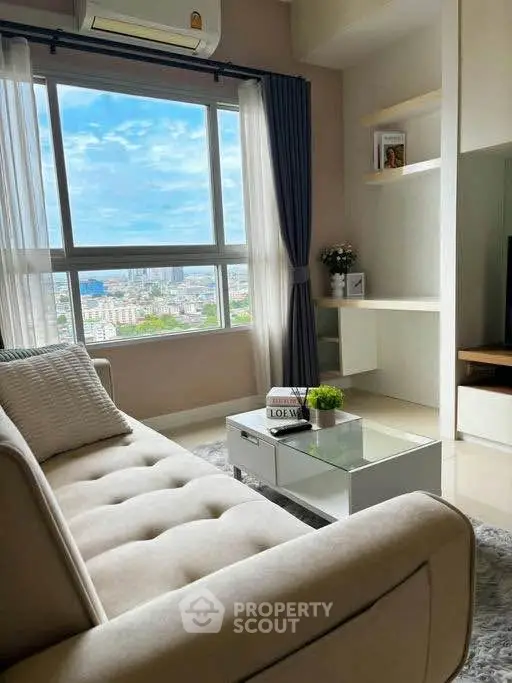 Modern living room with large window offering stunning city view, cozy sofa, and stylish decor.