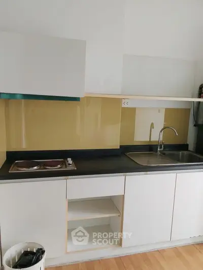 Modern kitchen with sleek cabinetry and built-in stovetop, perfect for urban living.