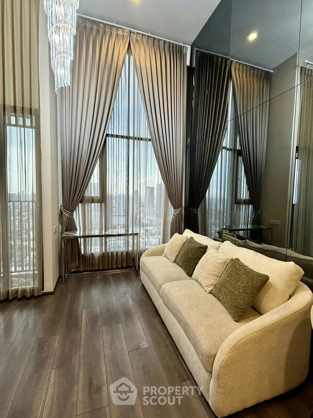 Luxurious living room with high ceilings, elegant curtains, and plush sofa in modern apartment.