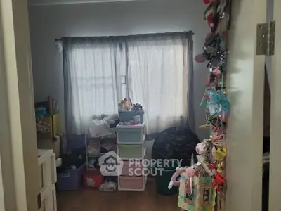 Cozy bedroom with ample storage and natural light, perfect for a child's playful retreat.