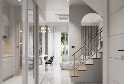 Modern open-plan living area with elegant staircase and stylish dining space.