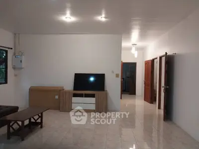 Spacious living room with modern furniture and tiled flooring
