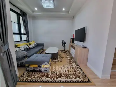 Modern living room with stylish sofa and large TV setup