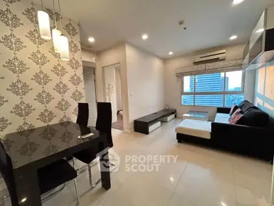 Modern living room with elegant dining area and city view, featuring stylish furniture and contemporary lighting.