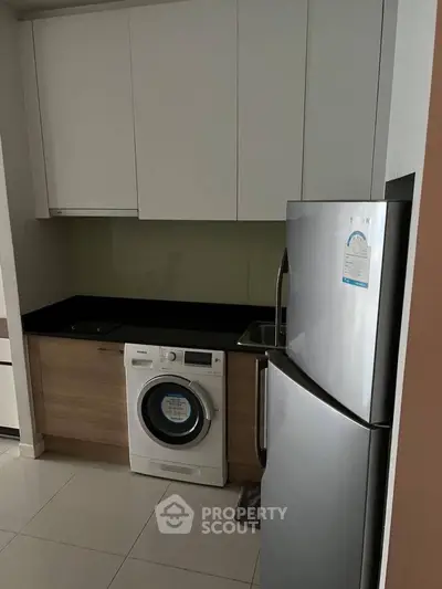 Modern kitchen with sleek appliances and compact design for efficient living.