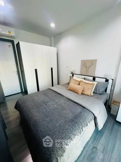 Modern bedroom with stylish decor and ample storage space