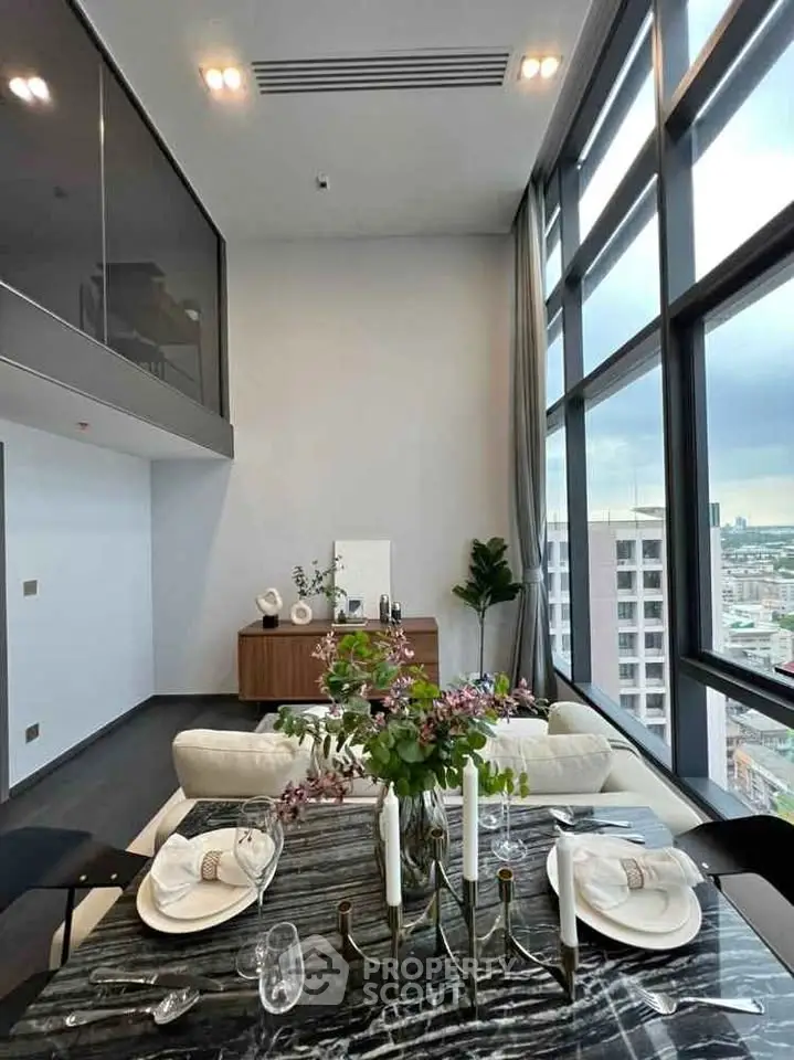 Luxurious high-rise living room with floor-to-ceiling windows and elegant dining setup.