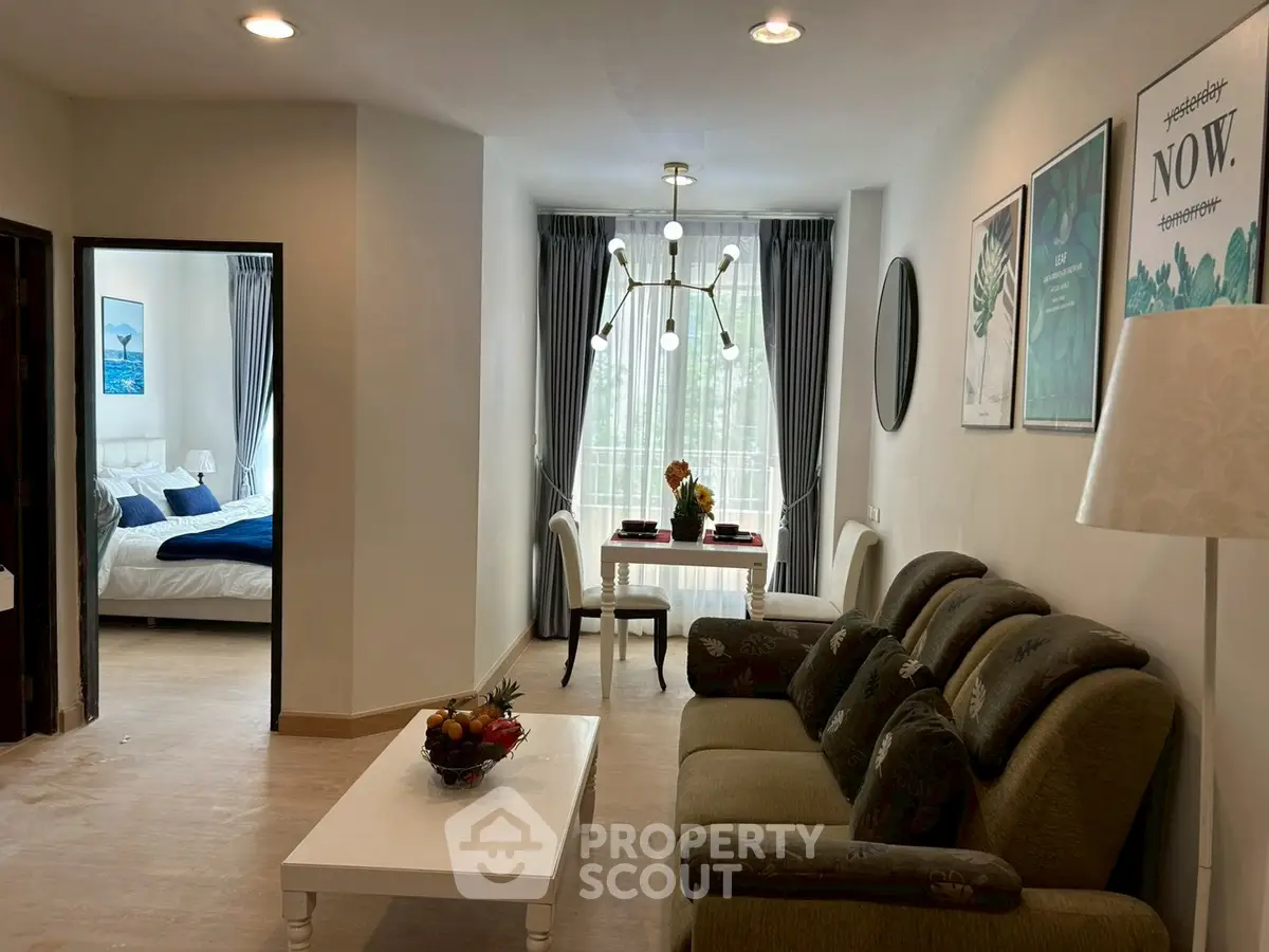 Chic living room with elegant decor and cozy bedroom view, perfect for modern urban living.