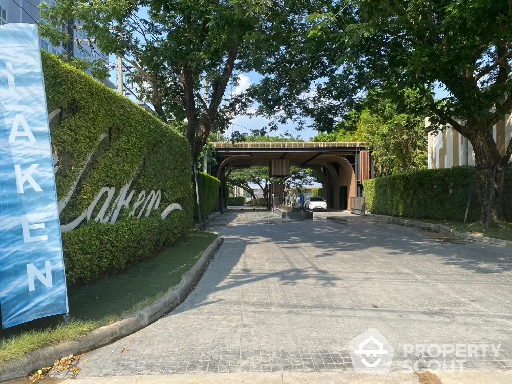 Elegant entrance with lush greenery and modern design, perfect for upscale living.