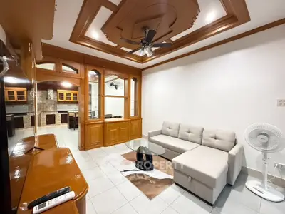 Spacious living room with modern ceiling design and cozy sectional sofa