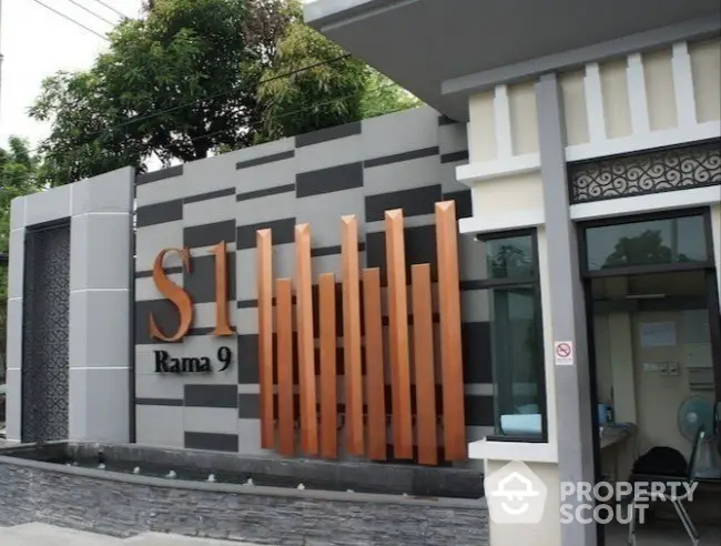 Modern building entrance with stylish facade and signage at S1 Rama 9