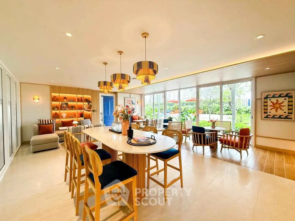 Spacious open-plan living and dining area with modern decor and garden view.